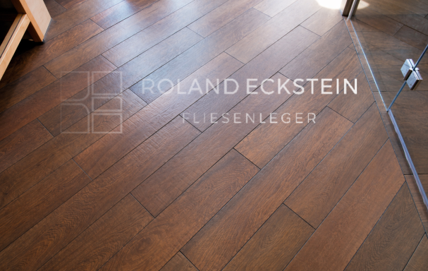 Brauner Holzboden mit sichtbaren Dielen und natürlicher Holzmaserung.